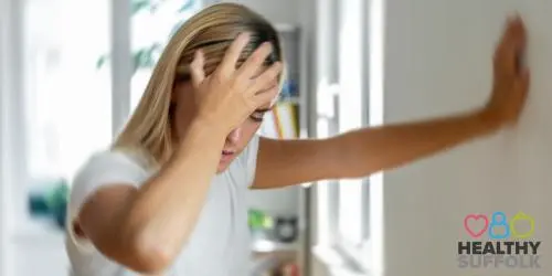 Young woman holding their head