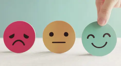 Three face emojis, unhappy, neutral and happy.