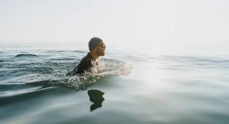 A man swimming in a lake